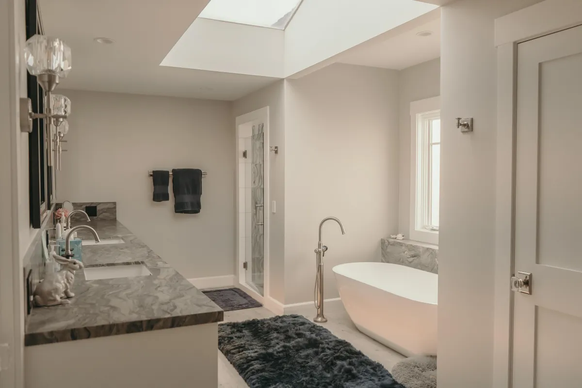 Spa-style primary bathroom by KSH Construction